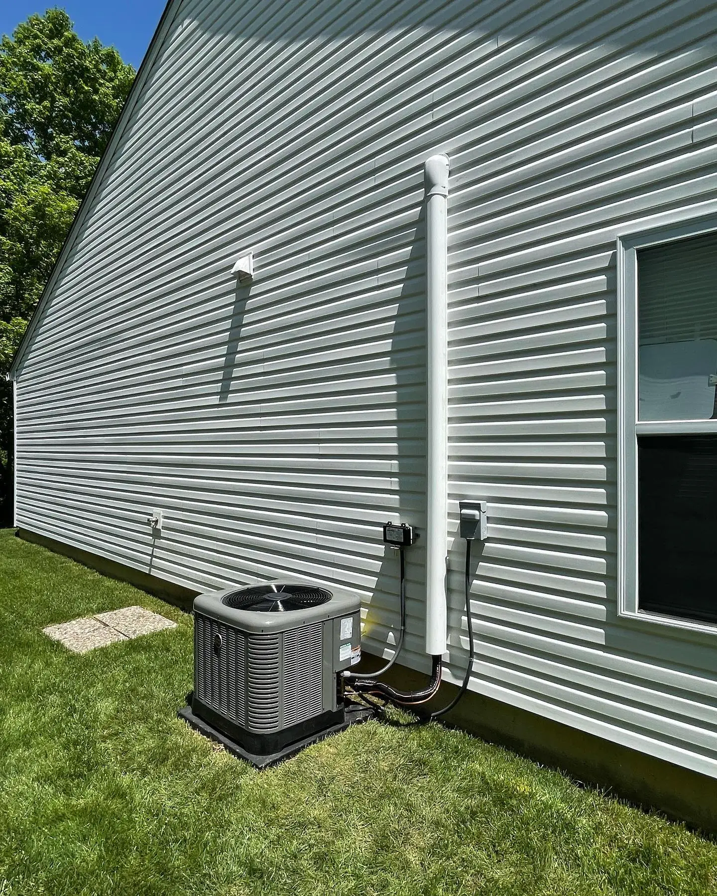 Outdoor AC condenser inspection at a Hendricks County home