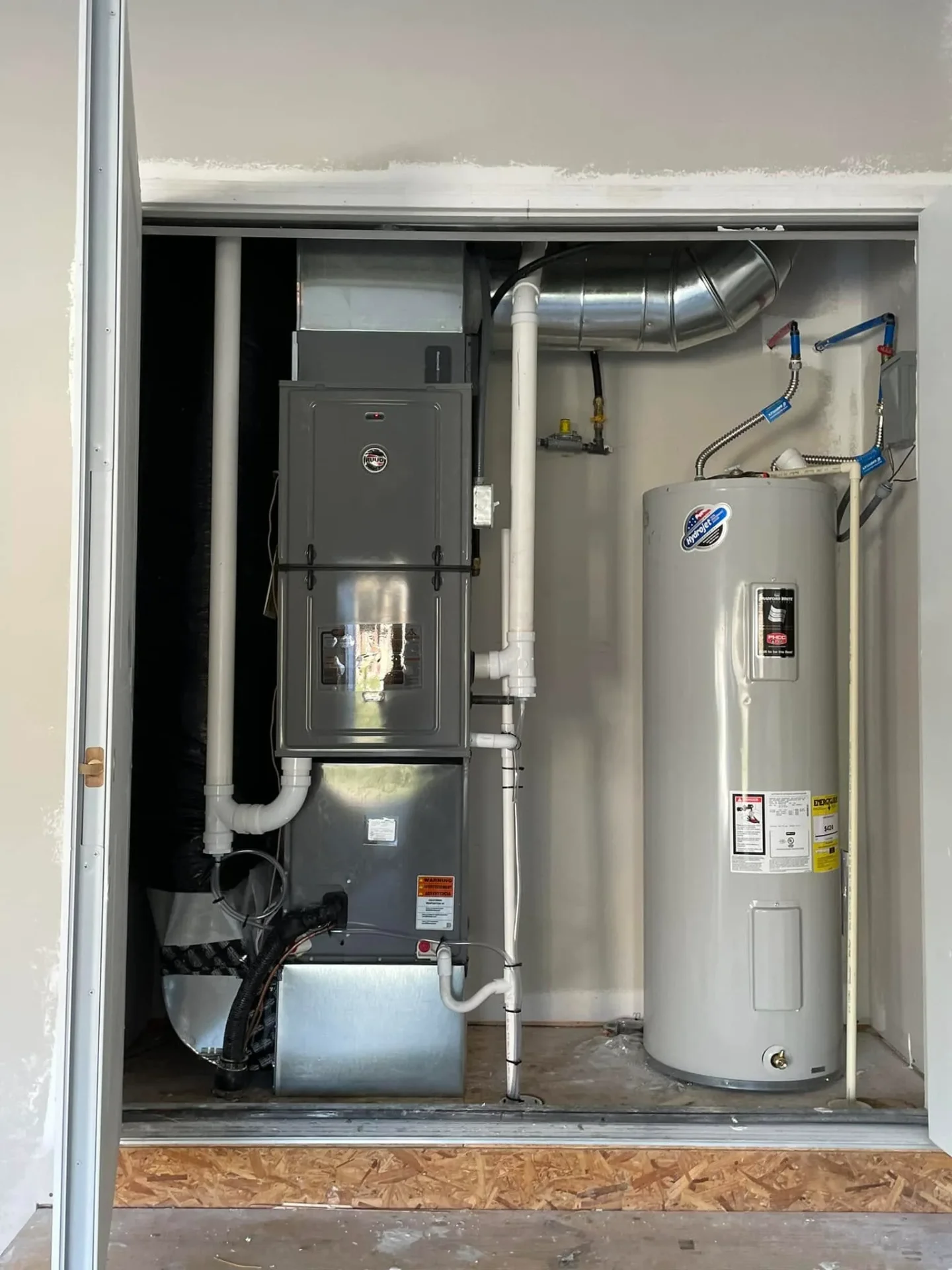 Ruud furnace + water heater closet install in a Clayton-area utility room