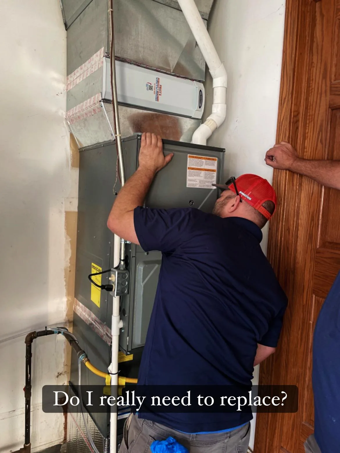 Polley's Perfect Seasons technician inspecting a furnace during a Plainfield, IN maintenance tune-up