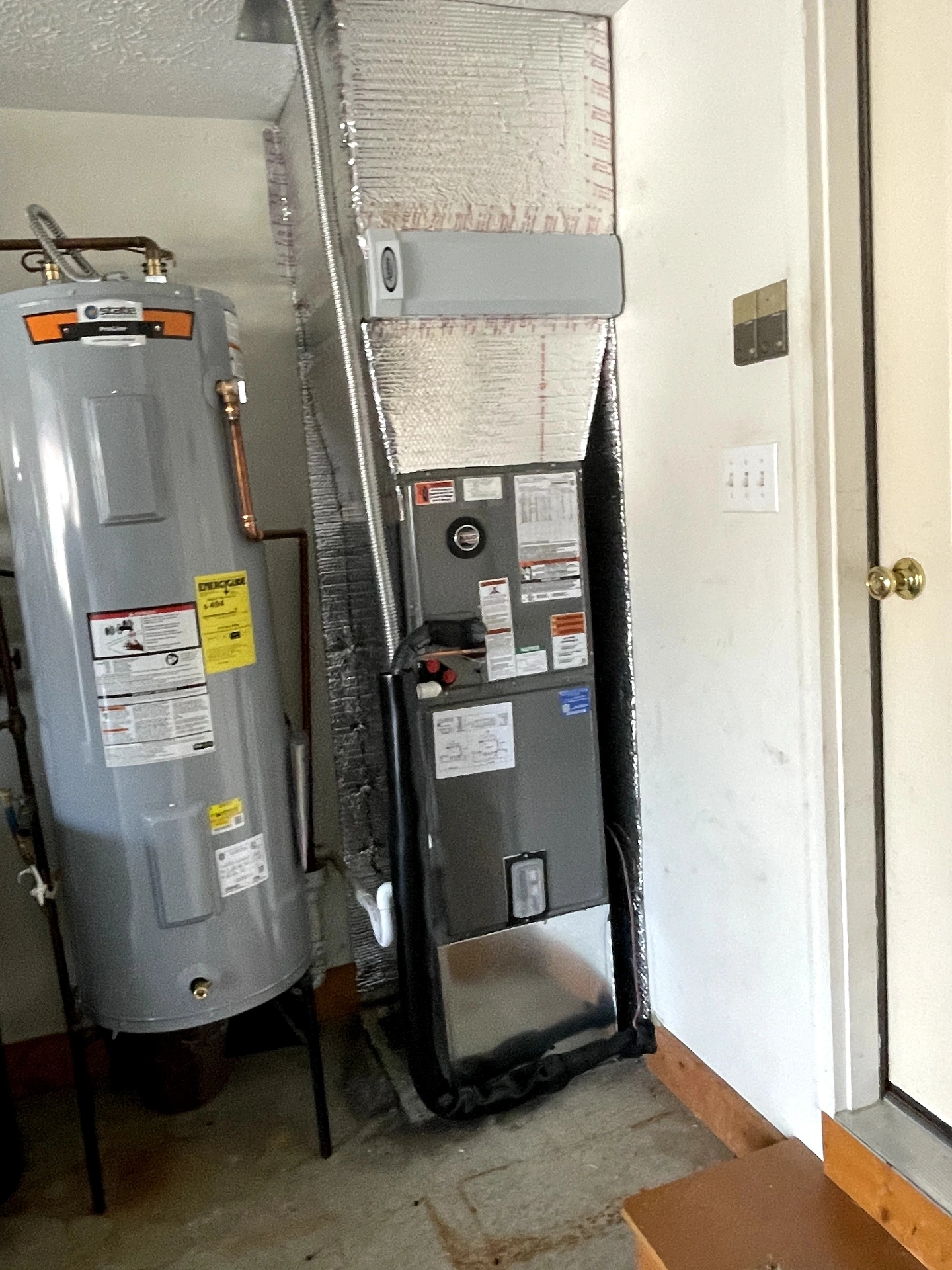 Water heater installed next to a new air handler in Clayton, IN